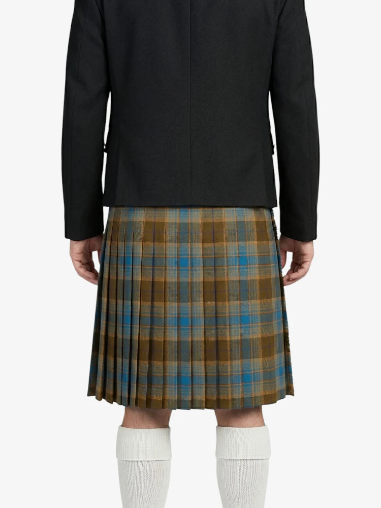 Person wearing a black jacket and plaid kilt on a white background
