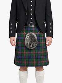 Person wearing a traditional Scottish kilt with a plaid pattern on a white background