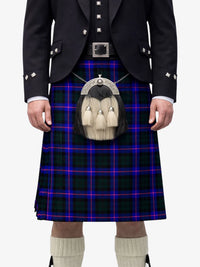 Person wearing a traditional Scottish kilt with a tartan pattern on a white background