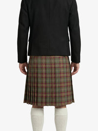 Person wearing a black jacket and plaid kilt on a white background