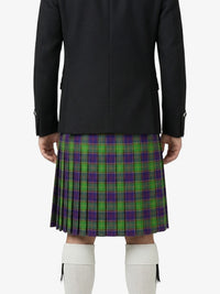 Person wearing a black coat and green plaid kilt on a white background