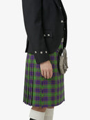 Person wearing a green and purple plaid kilt with a black jacket and sporran on a white background