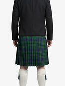 Person wearing a black jacket and green plaid kilt on a white background