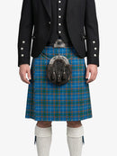 Person wearing a black jacket, blue plaid kilt, and white knee-high socks on a white background