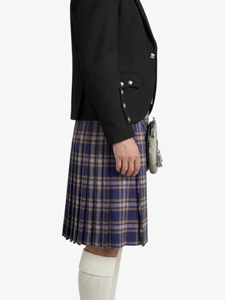Person wearing a black blazer and plaid kilt on a white background