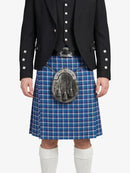 Person wearing a blue plaid kilt with a black jacket on a white background