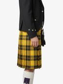 Person wearing a black jacket and yellow plaid kilt on a white background