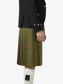 Person wearing a black jacket and green plaid kilt on a white background