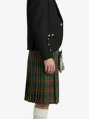 Person wearing a black jacket and green plaid kilt on a white background