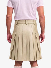 A beige pleated mini kilt with side cargo pockets, modeled from the back on a person wearing a light pink t-shirt and white socks against a plain white background.