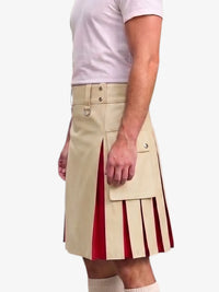 A man wearing a beige kilt with red pleated side panels, paired with a white t-shirt and white socks, shown from the chest down against a light gray background.