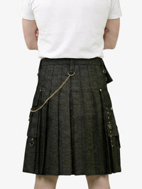 Person wearing a dark gray kilt with gold chain on a white background