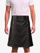 A black faux-leather kilt with silver-tone hardware, worn by a model in a white t-shirt against a light gray background.