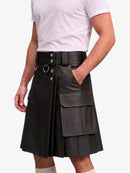 A black faux-leather kilt with a wide matching belt, silver-tone hardware, and a large front cargo pocket, shown on a model wearing a white t-shirt against a light gray background.