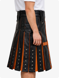 Black leather kilt with orange accents worn by a person on a white background