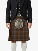 Person wearing a traditional Scottish kilt with a tartan pattern on a white background