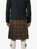 Person wearing a black jacket and brown plaid kilt on a white background