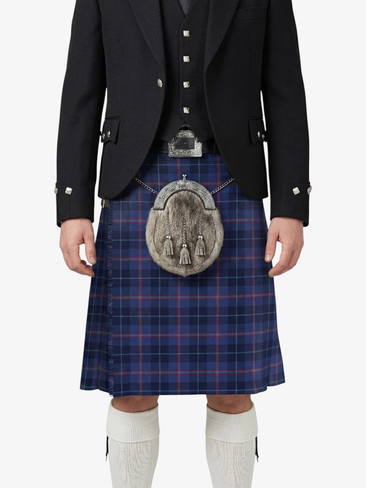Person wearing a traditional Scottish kilt with a tartan pattern on a white background