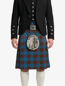 Person wearing a traditional Scottish kilt with a tartan pattern on a white background