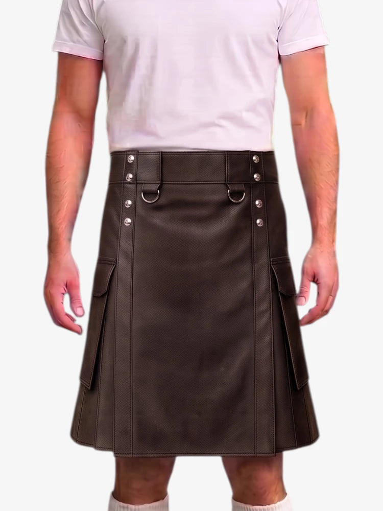 A man wearing a dark brown faux-leather kilt with silver-tone metal hardware and side pockets, paired with a light pink t-shirt and white socks, shown from the chest down against a white background.