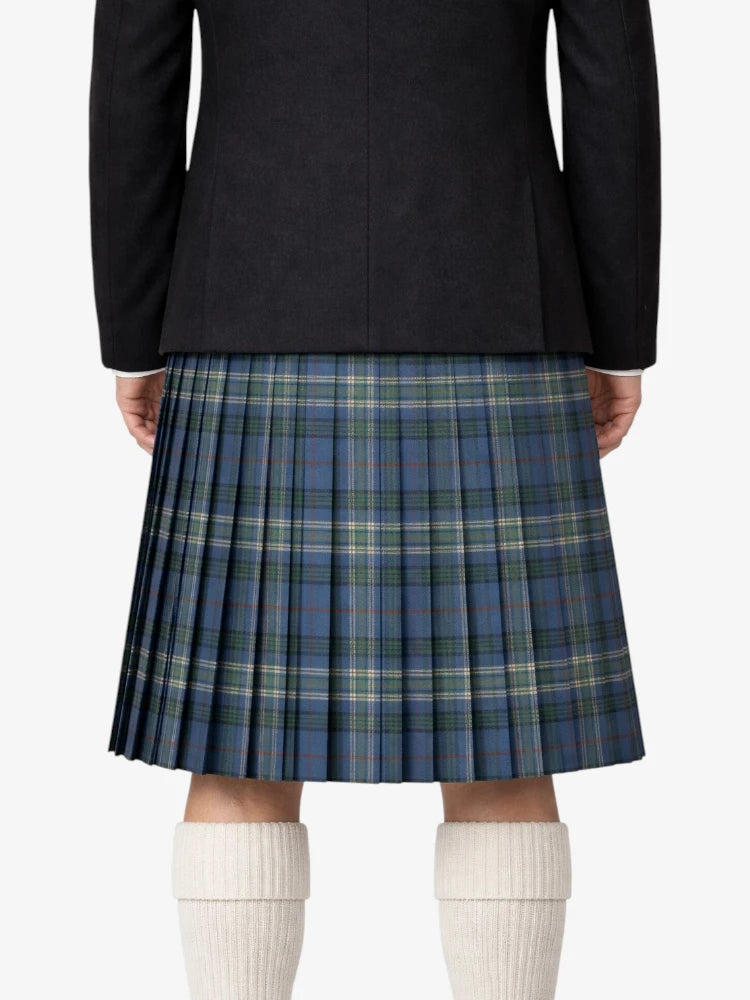 Person wearing a black jacket and blue plaid kilt on a white background