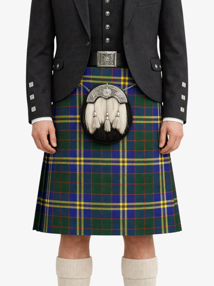 Person wearing a traditional Scottish kilt with a tartan pattern on a white background