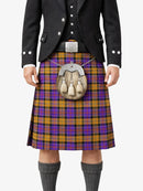 Person wearing a traditional Scottish kilt with a tartan pattern on a white background