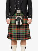 Person wearing a traditional Scottish kilt with a tartan pattern on a white background