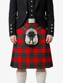 Person wearing a red tartan kilt with a black jacket and white socks on a white background