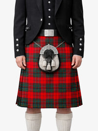 Person wearing a red tartan kilt with a black jacket and white socks on a white background
