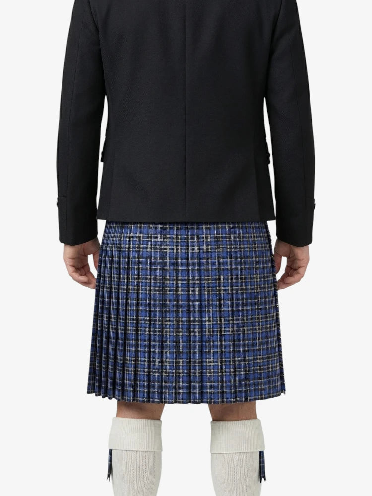 Person wearing a black jacket and blue plaid kilt on a white background