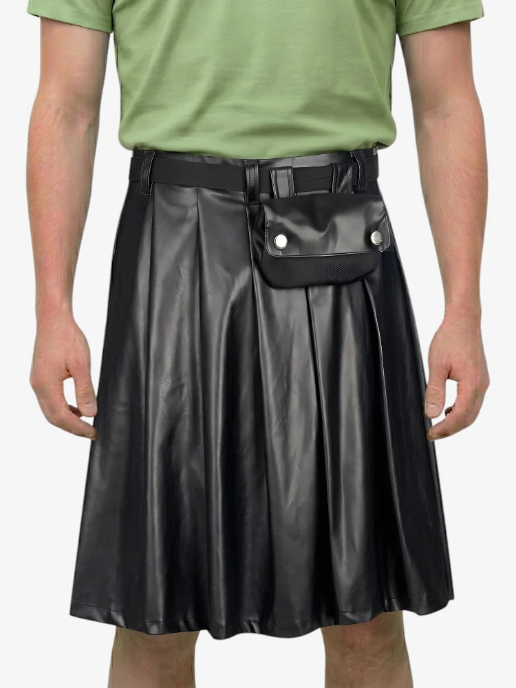 Person wearing a black leather skirt with a green shirt on a white background