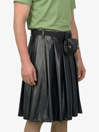 Person wearing a black leather skirt with a green shirt on a white background