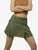 Green skirt with chain details worn by a person on a white background