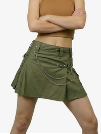Green skirt with chain details worn by a person on a white background