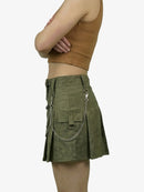Person wearing a green skirt with chain details on a white background