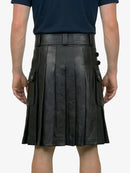Person wearing a black leather kilt on a white background