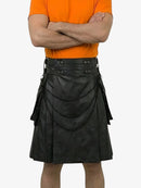 Person wearing a black leather kilt with decorative elements on a white background