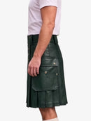 A dark green faux-leather kilt with pleated detailing and flap pockets, shown on a model wearing a white t-shirt against a light gray background.