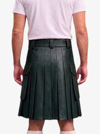 A dark forest green pleated faux leather kilt with side cargo pockets, modeled from the back on a person wearing a light pink t-shirt against a white background.