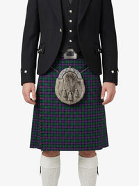 Person wearing a traditional Scottish kilt with a tartan pattern on a white background