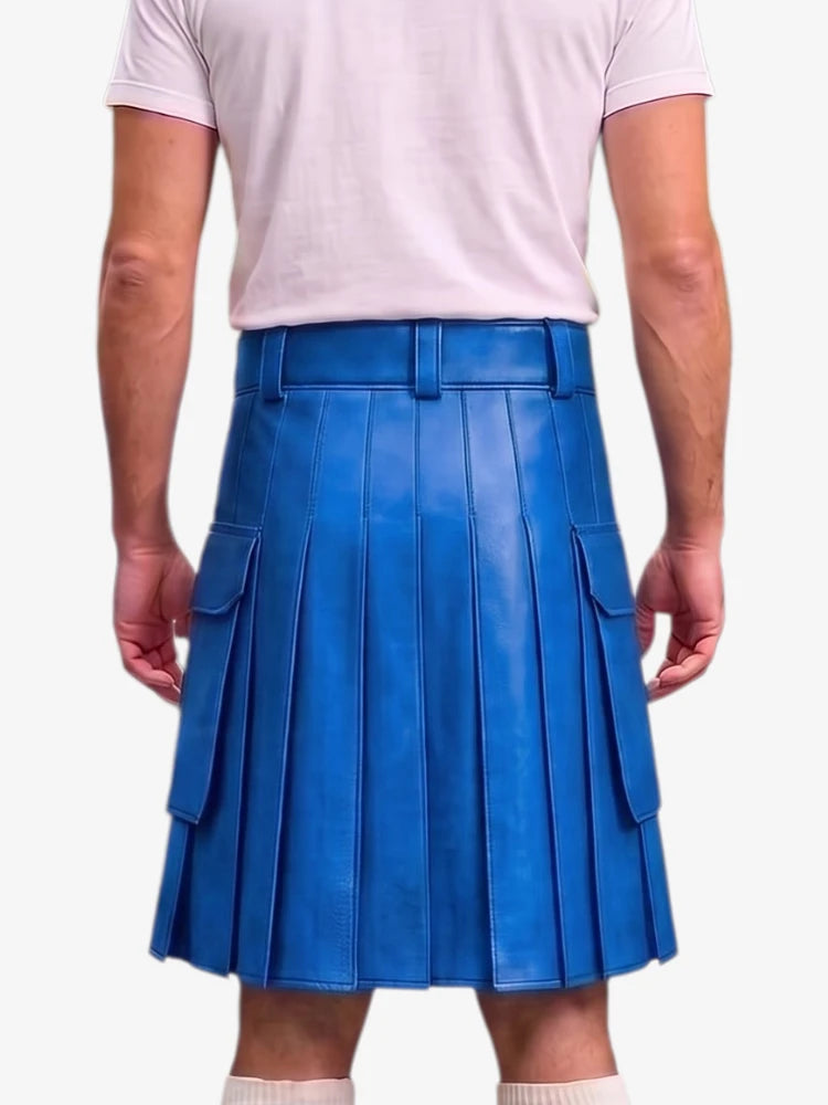 A person shown from the back wearing a bright blue pleated leather kilt with side flap pockets, paired with a light pink t-shirt and white socks, against a plain light gray background.