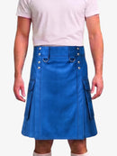 A man wearing a bright blue faux-leather kilt with silver-tone metal hardware, side pockets, and a matching belt, paired with a light pink t-shirt.