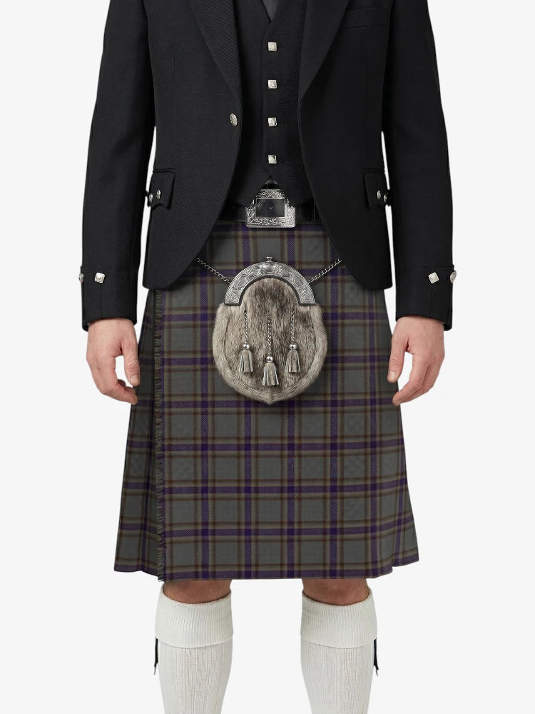 Person wearing a traditional Scottish kilt with a tartan pattern on a white background