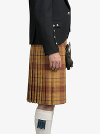 Person wearing a black jacket and yellow plaid kilt on a white background