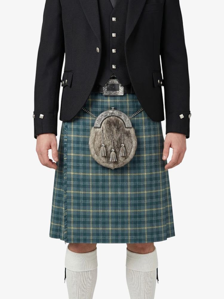 Person wearing a traditional Scottish kilt with a jacket on a white background