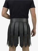 Person wearing a black pleated skirt with a plain background