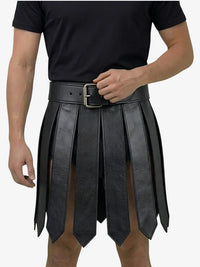 Person wearing a black leather skirt with a belt on a white background