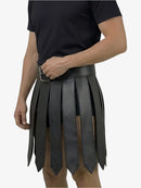 Person wearing a black leather skirt with a belt on a white background
