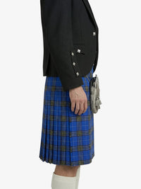 Person wearing a black blazer and blue plaid kilt on a white background